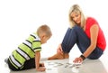 Mother playing puzzle together with her son Royalty Free Stock Photo