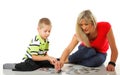 Mother playing puzzle together with her son Royalty Free Stock Photo