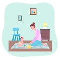 Mother playing with toddler girl at carpet, ball, cube toys, happy woman looking at her daughter Royalty Free Stock Photo