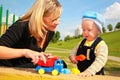 Mother plays with child with toy car Royalty Free Stock Photo