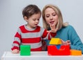 Mother plays with her son in dice Royalty Free Stock Photo