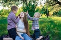 Mother plays with her sons outdoors. Young mom and two children having fun Royalty Free Stock Photo