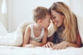 Mother plays with son in bed Royalty Free Stock Photo