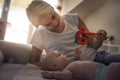 Mother plying with her little baby boy at home and holdi Royalty Free Stock Photo