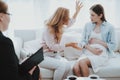 Mother with Pregnant Daughter in Doctor Office