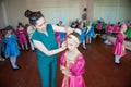 Mother prepares her unhappy daughter for a concert at the dance school