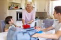 Mother preparing healthy lunch boxes for her two sons