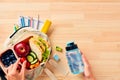 Mother preparing healthy school lunch box for children. Top view Royalty Free Stock Photo