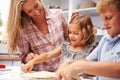 Mother preparing pizza with kids Royalty Free Stock Photo