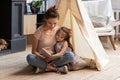 Mother and preschooler daughter hugging read fairytale