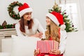 Mother presenting christmas gift for daughter