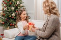 Mother presenting gift to daughter Royalty Free Stock Photo