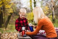 Family picnic with thermos in autumn park