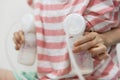 Mother pumping breastmilk into bottles