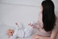 Mother pumping milk to bottles by Automatic breast pump machine .The newborn baby is crying, he wants to eat