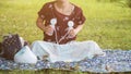 Mother pumping breastmilk in park at sunset