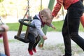 Mother Pushing Baby Boy Having Fun on Swing Royalty Free Stock Photo