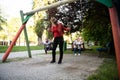 Mother Pushing Her Baby`s Having Fun on Swing Royalty Free Stock Photo