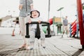 Mother pushing her infant baby boy child on a swing on playground outdoors.