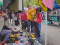 A mother puts a headscarf on her child