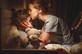 Mother puts her daughter to bed and kisses her in evening Royalty Free Stock Photo