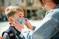 Mother puts a safety mask on her son`s face. Schoolboy is ready go to school. Back to school concept Royalty Free Stock Photo