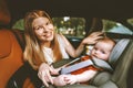 Mother putting baby in safety car seat happy family Royalty Free Stock Photo