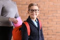 Mother putting copybooks in backpack of her son before school Royalty Free Stock Photo