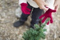 Mother Putting Red Mittens On Child Outdoors