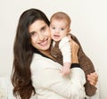 Mother raising baby and play, happy family portrait on white background, yellow toned Royalty Free Stock Photo