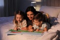 Mother reading bedtime story to her children at home Royalty Free Stock Photo