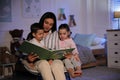 Mother reading bedtime story to her children at home Royalty Free Stock Photo