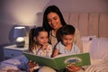 Mother reading bedtime story to her children at home Royalty Free Stock Photo