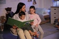 Mother reading bedtime story to her children at home Royalty Free Stock Photo