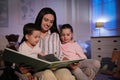 Mother reading bedtime story to her children Royalty Free Stock Photo