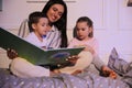 Mother reading bedtime story to children at home Royalty Free Stock Photo