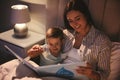 Mother reading bedtime story to her son at home Royalty Free Stock Photo