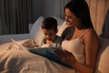 Mother reading bedtime story to her son at home Royalty Free Stock Photo