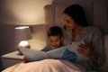 Mother reading bedtime story to her son at home Royalty Free Stock Photo