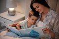 Mother reading bedtime story to son at home Royalty Free Stock Photo