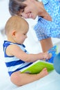 Mother reading book baby in bed Royalty Free Stock Photo