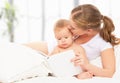 Mother reading book baby in bed before going to sleep Royalty Free Stock Photo