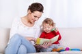 Mother reading book with child