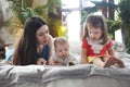 Mother reading a book with her daughter and son in bedroom Royalty Free Stock Photo