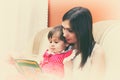 Mother reading a book with her little daughter Royalty Free Stock Photo