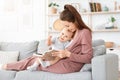 Mother reading book to her cute little toddler son at home Royalty Free Stock Photo