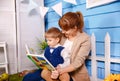 Mother reading a book to her little boy. Mom is reading bedtime story Royalty Free Stock Photo