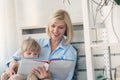 Mother reading a book to her young daughter at home Royalty Free Stock Photo