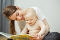 Mother reading to little infant colorful book with fairy tales. Royalty Free Stock Photo