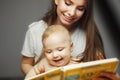 Mother reading to little infant colorful book with fairy tales. Royalty Free Stock Photo